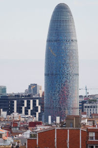 Buildings in city against clear sky