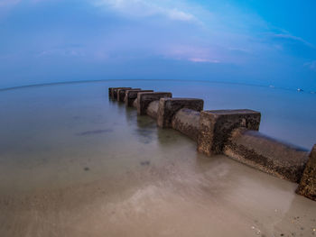 Scenic view of sea against cloudy sky