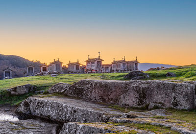 View of temple against buildings at sunset