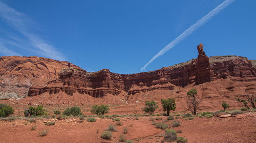 Scenic view of rocky mountains against blue sky