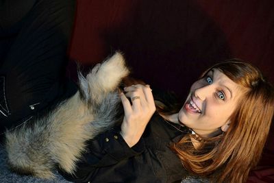 Portrait of woman wearing spooky contact lens lying on bed