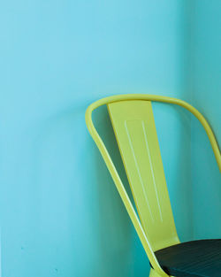 High angle view of empty chair against blue background