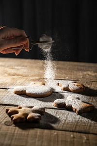 Person holding ice cream on table