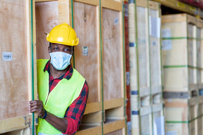 Portrait of worker wearing hardhat and mask