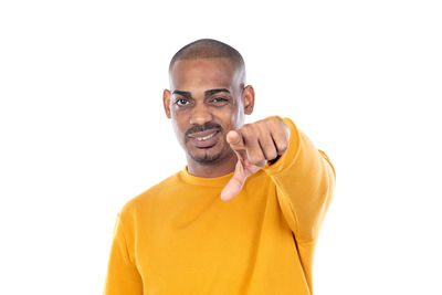 Portrait of young man standing against white background