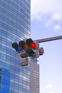 Low angle view of road signal against sky