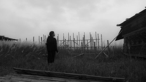 Woman stands on the outskirts of town