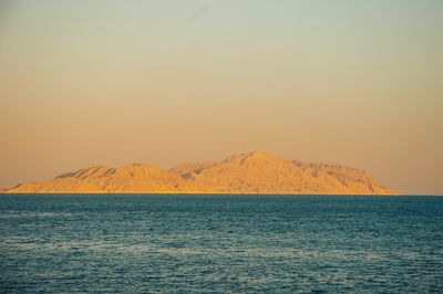 Scenic view of lake against sky at sunset