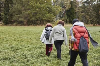 Group of friends walking through meadow