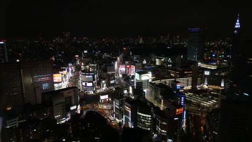 Illuminated cityscape against sky at night