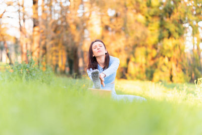 Portrait of young woman in park during autumn