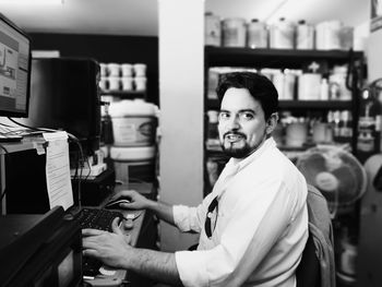 Portrait of smiling man working in office