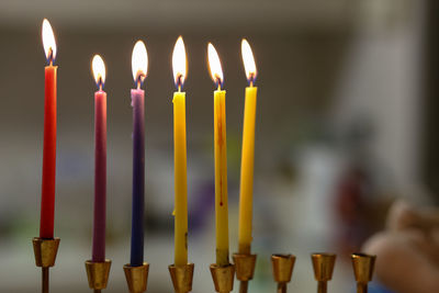Close-up of colorful burning candles in church