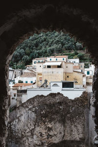 Buildings on rock against sky