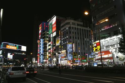 Illuminated city against sky at night