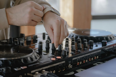 Midsection of man using sound mixer