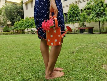 Midsection of woman standing on field