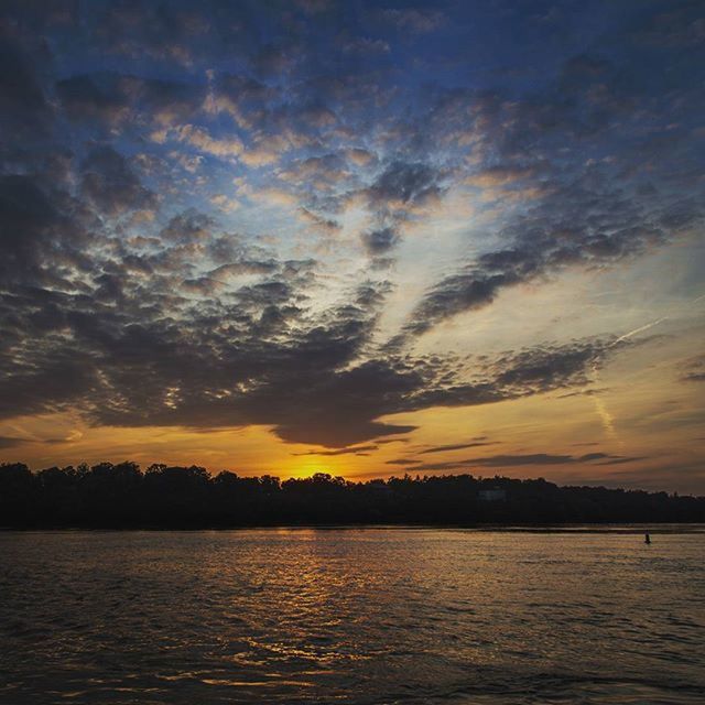 sunset, water, scenics, sky, tranquil scene, waterfront, beauty in nature, tranquility, orange color, cloud - sky, silhouette, idyllic, nature, sea, cloud, dramatic sky, reflection, lake, cloudy, moody sky