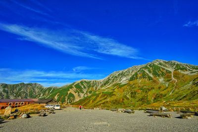 Scenic view of mountains against blue sky