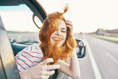 Portrait of smiling young woman in car