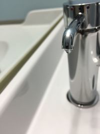 Close-up of dripping faucet on sink