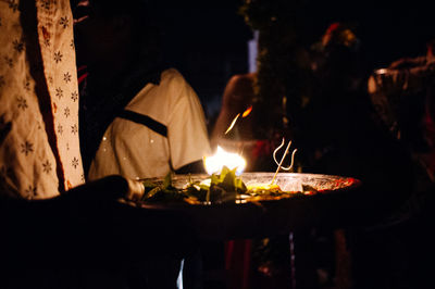 Close-up of lit candle in dark room