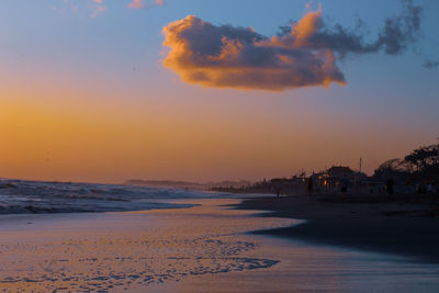 Scenic view of beach against sky during sunset