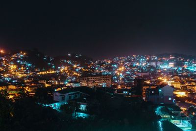 High angle view of illuminated buildings in city at night