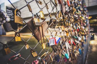 Close-up of padlocks hanging on railing