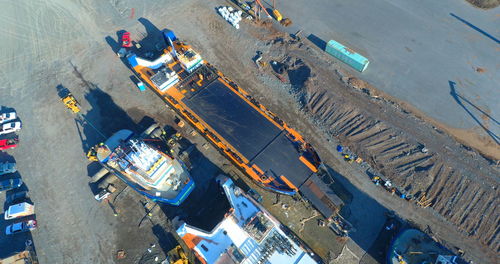 High angle view of commercial dock on road by pier