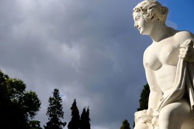 Low angle view of angel statue against sky