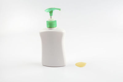 Close-up of soap dispenser against white background