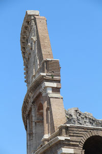 Low angle view of historical building against clear blue sky