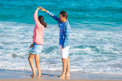 Full length of woman standing at beach