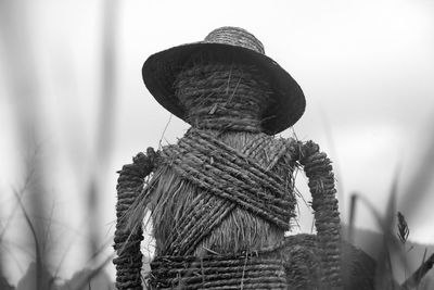 Close-up of scarecrow on field against sky