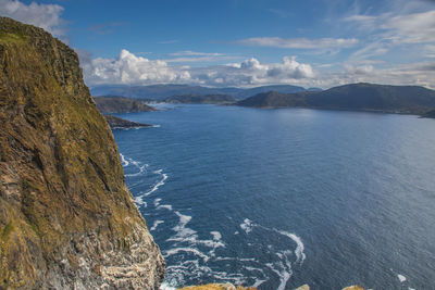 Scenic view of sea and mountains against sky