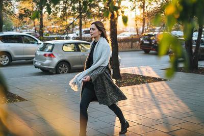 Rear view of woman standing on street