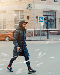 Full length of young woman standing on road