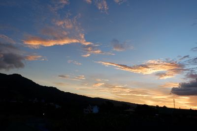 Scenic view of silhouette mountains against sky at sunset