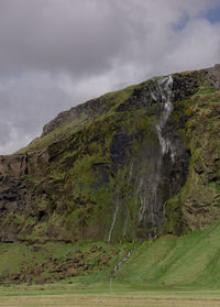 Scenic view of waterfall against sky