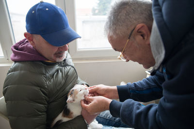 Close-up of man holding cat