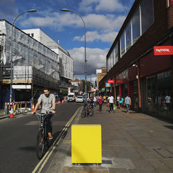 People walking on road along buildings