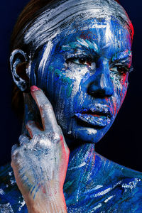 Portrait of woman painted blue