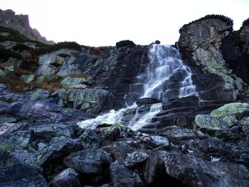 Scenic view of waterfall against clear sky