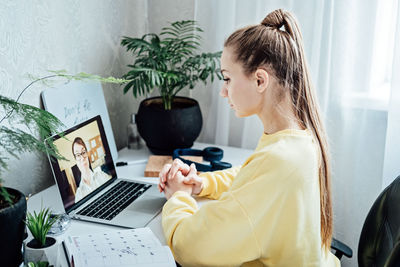 Young woman student applicant having online virtual video call job interview meeting with female hr