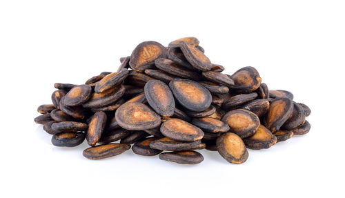 Close-up of coffee beans against white background