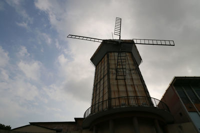 Low angle view of traditional windmill against sky