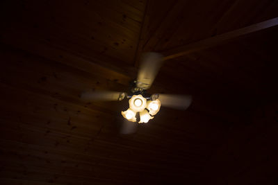 Low angle view of lighting equipment hanging from ceiling at home