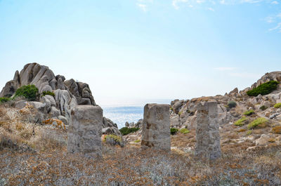 Scenic view of rocky beach against sky