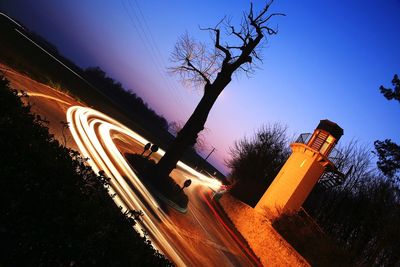 Railroad track against sky at night
